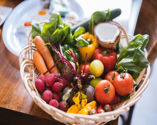 Fresh colorful vegetables and fruits on a kitchen table